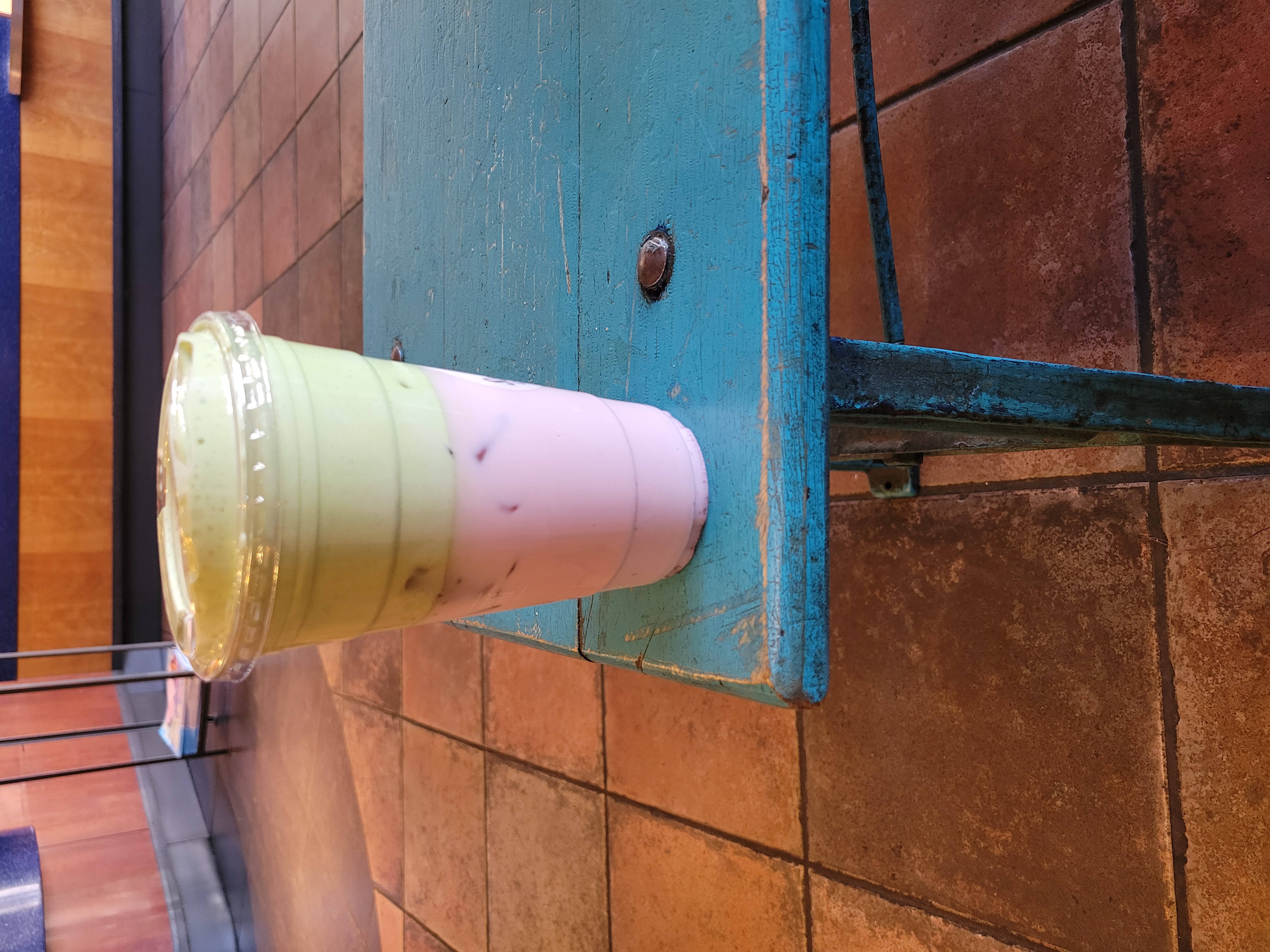 Plastic cup of strawberry matcha.